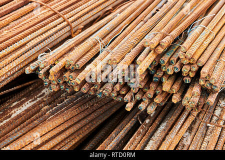 Close-up of a pile of rusty steel bars, marked on its end, and held together with wire, commonly used in the asian construction industry Stock Photo