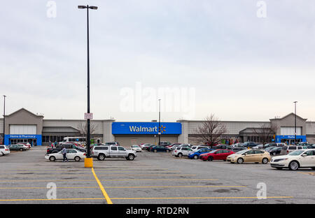 HICKORY, NC, USA-2/28/19: A Walmart store with main sign, and, Market, Home & Pharmacy signs.  Parking lot with cars and multiple people. Stock Photo