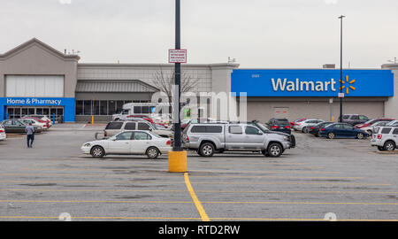 HICKORY, NC, USA-2/28/19: A Walmart store with sign, and Home & Pharmacy sign.  Parking lot with cars and one person. Stock Photo