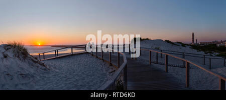 Sunset, Praia do Paredão, Farol da Barra, beach and lighthouse, Praia da Barra, Aveiro,  Portugal Stock Photo