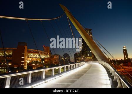 The iconic, modern 500-feet long Harbor Drive Pedestrian Bridge at sunrise, connects Petco Park to San Diego Bay and Convention Center, San Diego, USA