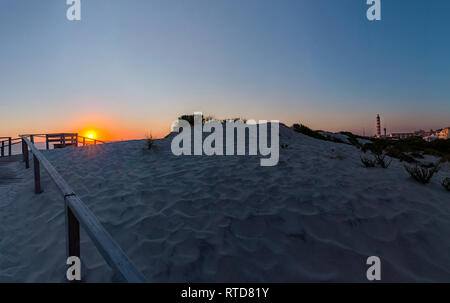 Sunset, Praia do Paredão, Farol da Barra, beach and lighthouse, Praia da Barra, Aveiro,  Portugal Stock Photo