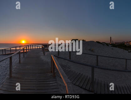 Sunset, Praia do Paredão, Farol da Barra, beach and lighthouse, Praia da Barra, Aveiro,  Portugal Stock Photo