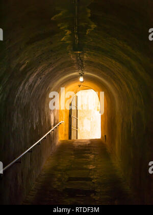 Yellow light in a dark tunnel Stock Photo