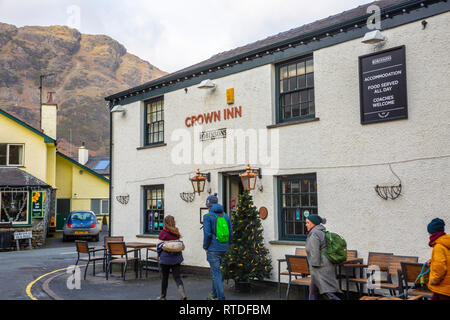 Walkers at the Crown Inn in Coniston village, Lake District national park,Cumbria,England Stock Photo