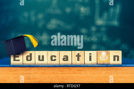 Cubes with word " education " and graduation hat on cubes , education concept Stock Photo