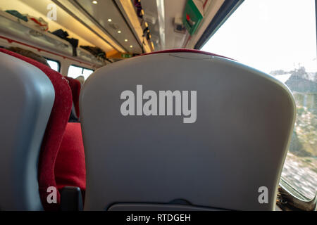 Train passengers view of seat headrest in front Stock Photo