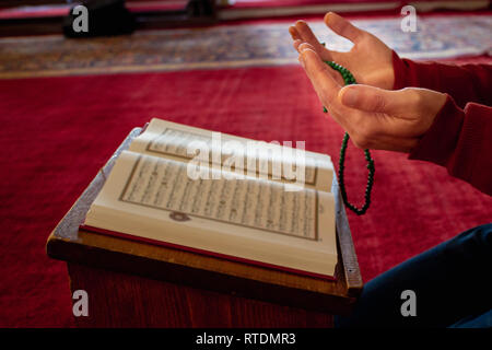 Muslim people hands prays and reading the Quran at the mosque Stock Photo