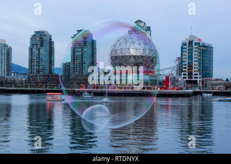 Downtown Vancouver, British Columbia, Canada - November 29, 2018: Big bubble flying in False Creek during a vibrant sunset. Stock Photo