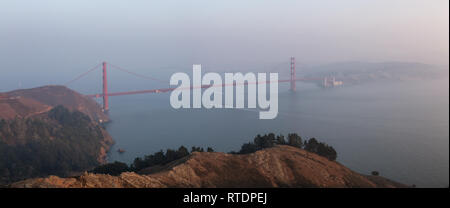 Beautiful panoramic view of Golden Gate Bridge during a hazy sunset. Taken in San Francisco, California, United States. Stock Photo