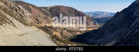 Panoramic view of a scenic road, Tioga Pass, in the Valley surrounded by mountains. Taken near Lee Vining, California, United States. Stock Photo
