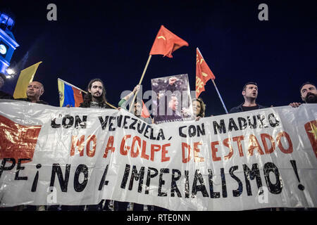 Demonstrators seen holding a banner during the protest. Hundreds of people march in the streets of Madrid to protest against the intervention of United States in Venezuela. Stock Photo