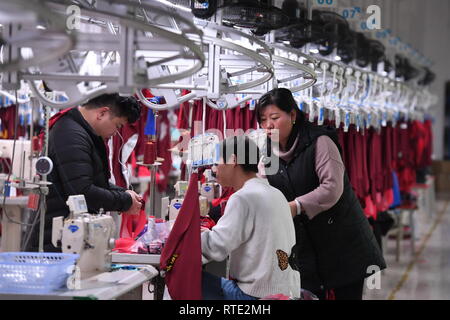 (190301) -- QUANZHOU, March 1, 2019 (Xinhua) -- Quality controller Ma Peijuan checks the products on the production line at Kelme China in Jinjiang, Quanzhou, southeast China's Fujian province, Feb. 26, 2019. The Spanish sports brand Kelme, now held by the Chinese clothing company Yuanxiang, has recently got popular among Chinese soccer fans. The craze comes as Chinese soccer player Wu Lei was recently recruited by the Spanish Liga Santander club Espanyol, whose official kit sponsor is none other than Kelme. Within just one month, more than 10,000 Wu Lei jerseys were sold in China, bringing al Stock Photo