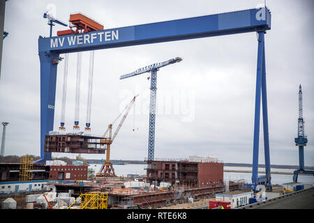 01 March 2019, Mecklenburg-Western Pomerania, Rostock: A prefabricated ship section is lifted in the dry dock from MV yards onto the Global Class cruise ship under construction. Three years after taking over the Nordic Yards in Wismar, Rostock and Stralsund, the management of MV shipyards is providing information on current projects. Between 2016 and 2019, the workforce was doubled from 1,400 to more than 2,800 employees. Photo: Jens Büttner/dpa-Zentralbild/dpa Stock Photo