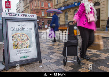 Vegetarianism, vegan, vegetarian, veganism, vegans diet foods; Pizza Express Vegan Giardiniera men board; Preston, Lancashire. 1st March 2019. UK Weather. Cold, damp inclement day in the town centre as Preston’s homeless people hope for donations on the city centre streets. Stock Photo