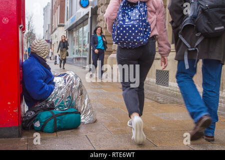 Preston, Lancashire. 1st March 2019. UK Weather. Cold, damp inclement day in the town centre as Preston’s homeless people hope for donations on the city centre streets. Trapped in the social system by having no fixed abode, they are unable to claim Universal Credit and resort to begging to hopefully acquire cash from passing shoppers, enough for a overnight hostel. Credit. MWI/AlamyLiveNews. Stock Photo