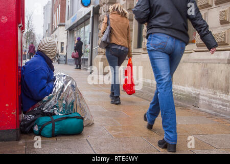 Preston, Lancashire. 1st March 2019. UK Weather. Cold, damp inclement day in the town centre as Preston’s homeless people hope for donations on the city centre streets. Trapped in the social system by having no fixed abode, they are unable to claim Universal Credit and resort to begging to hopefully acquire cash from passing shoppers, enough for a overnight hostel. Credit. MWI/AlamyLiveNews. Stock Photo