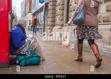 Preston, Lancashire. 1st March 2019. UK Weather. Cold, damp inclement day in the town centre as Preston’s homeless people hope for donations on the city centre streets. Trapped in the social system by having no fixed abode, they are unable to claim Universal Credit and resort to begging to hopefully acquire cash from passing shoppers, enough for a overnight hostel. Credit. MWI/AlamyLiveNews. Stock Photo