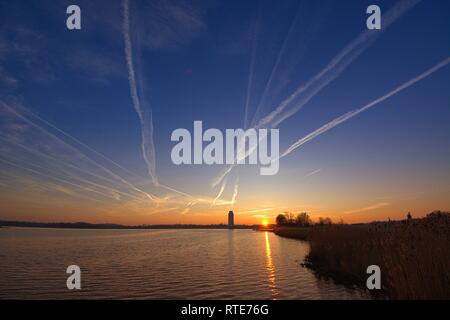 Code Strips in the sky over Schleswig at sunset in the early evening in late winter. In conspiracy theories, these thin clouds caused by airplanes are also referred to as chemtrails. Chemtrail is a portmanteau of the English chemical for chemicals and contrails for contrails, in German so about chemical strips. | usage worldwide Stock Photo