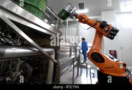 (190301) -- LANGFANG, March 1, 2019 (Xinhua) -- A staff of a Beijing-based honey maker tests equipment at a factory located in the Langfang Economic and Technological Development Zone in Langfang, north China's Hebei Province, March 1, 2019. The Langfang Economic and Technological Development Zone has seized the opportunities that come with the Beijing-Tianjin-Hebei coordinated development strategy in recent years, optimizing its industrial distribution by upgrading and transforming the old industries. Taking advantage of its location between Beijing and Tianjin, the development zone has gaine Stock Photo