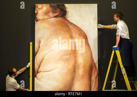 London, UK.  1 March 2019. Technicians hang ''Juncture'', 1994, by Jenny Saville, (Est. £5,000,000 - 7,000,000).  Preview of Sotheby's Contemporary Art Sale in their New Bond Street galleries.  Works by artists including Tracey Emin, Jenny Saville, Jean-Michel Basquiat and Andy Warhol will be offered for auction on 5 March 2019.   Credit: Stephen Chung / Alamy Live News Stock Photo