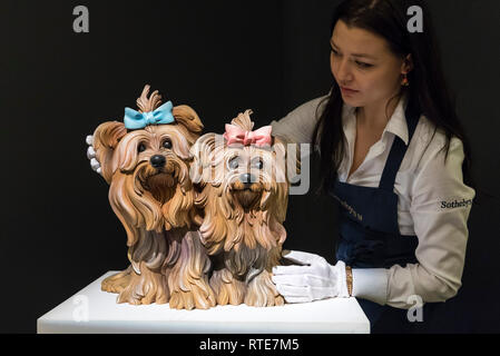 London, UK.  1 March 2019. A technician examines ''Yorkshire Terriers'', 1991, by Jeff Koons, (Est. £600,000 - 800,000).  Preview of Sotheby's Contemporary Art Sale in their New Bond Street galleries.  Works by artists including Tracey Emin, Jenny Saville, Jean-Michel Basquiat and Andy Warhol will be offered for auction on 5 March 2019.   Credit: Stephen Chung / Alamy Live News Stock Photo
