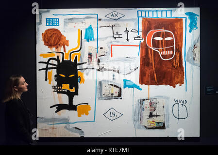 London, UK.  1 March 2019. A staff member views ''Apex'' by Jean-Michel Basquiat, (Est. £5-7m). Preview of Sotheby's Contemporary Art Sale in their New Bond Street galleries.  Works by artists including Tracey Emin, Jenny Saville, Jean-Michel Basquiat and Andy Warhol will be offered for auction on 5 March 2019.   Credit: Stephen Chung / Alamy Live News Stock Photo