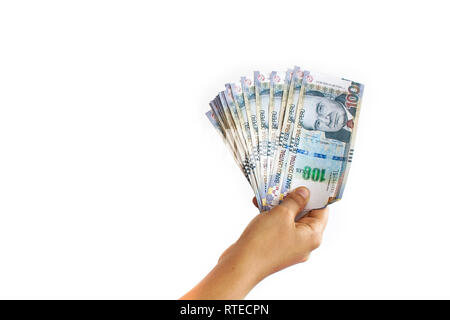 Close up of a hand holding 100 Peruvian soles bills in a fan shape on white background Stock Photo