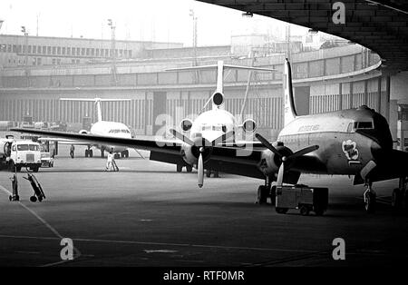 Civilian airlines are authorized to land at the Tempelhof Central Airport when bad weather prevents them from landing at the primary airport at Tegel.  The Rosinen Bomber is the first plane from the right. Stock Photo