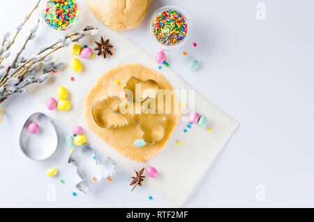 Happy Easter card. Easter biscuits,  cuttings, candy eggs and ingredients for baking rolled dough dough, copy space, top view Stock Photo