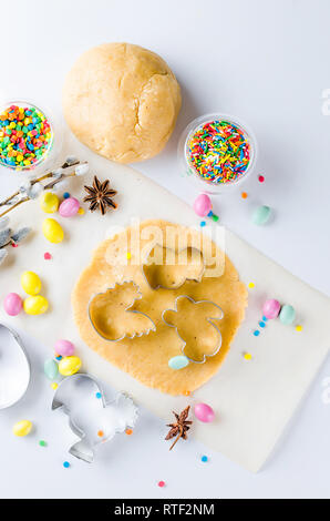 Happy Easter card. Easter biscuits,  cuttings, candy eggs and ingredients for baking rolled dough dough, copy space, top view Stock Photo