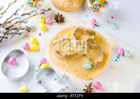 Happy Easter card. Easter biscuits,  cuttings, candy eggs and ingredients for baking rolled dough dough, copy space, top view Stock Photo