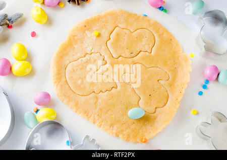 Happy Easter card. Easter biscuits,  cuttings, candy eggs and ingredients for baking rolled dough dough, copy space, top view Stock Photo
