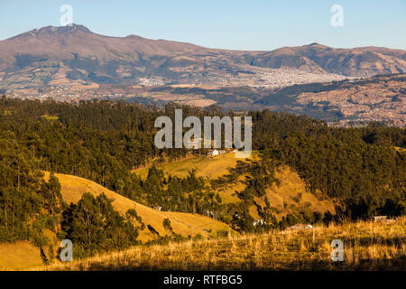 Andean landscape in the morning with golden and orange tones showing its arable hillsides and forests planted Stock Photo