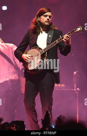 Musician Winston Marshall is shown performing on stage during a 'live' concert appearance with Mumford & Sons. Stock Photo