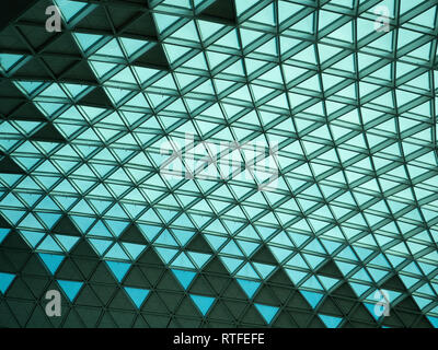 Ceiling in Incheon International Airport in South Korea with blue green pattern of glass triangles with metal latticework. Stock Photo