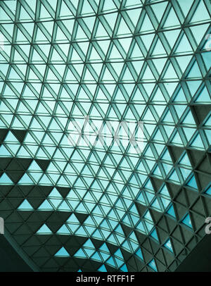 Ceiling in Incheon International Airport in South Korea with blue green pattern of glass triangles with metal latticework. Stock Photo