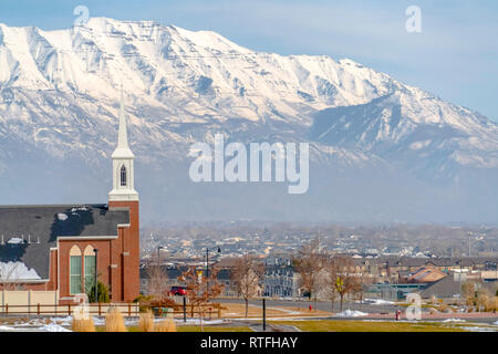 Eagle Mountain landscape against Mount Timpanogos. Scenic landscape in Eagle Mountain Utah with view of a church and distant homes. Striking snow capp Stock Photo