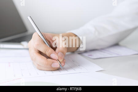 Business man is signing a document on office table Stock Photo