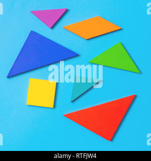 Colorful wooden tangram  puzzle toy on blue Stock Photo