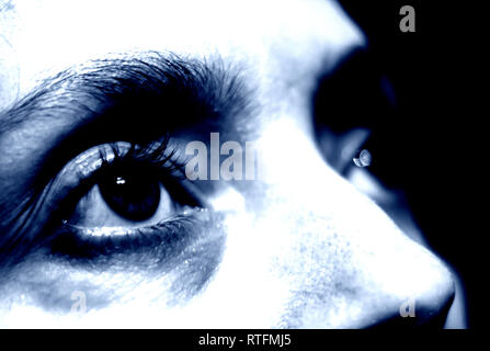 Conceptual and dramatic photo of a woman's eye close-up. Stock Photo