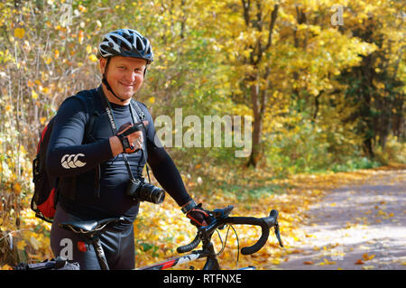 Kaliningrad region, Russia, October 13, 2018. Man with Bicycle in autumn forest. Stock Photo