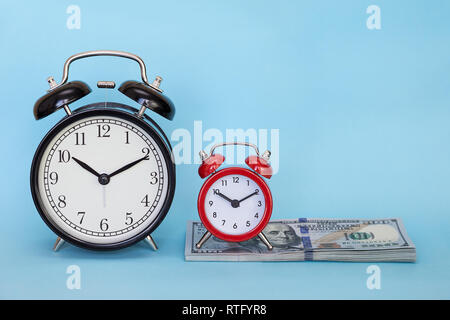 Retro alarm clock on a colored background. Concept - time is money Stock Photo