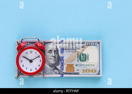 Retro alarm clock on a colored background. Concept - time is money Stock Photo