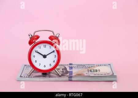 Retro alarm clock on a colored background. Concept - time is money Stock Photo