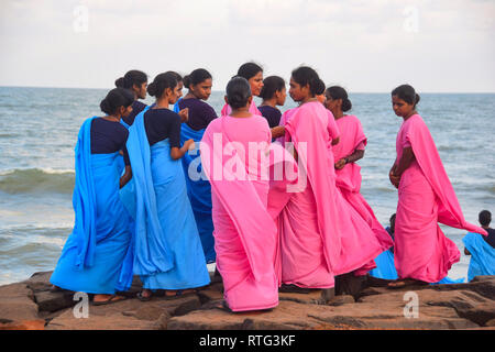 Indian Ladies on sea front in Pink and blue sarees, Pondicherry, Puducherry, Tamil Nadu, India Stock Photo