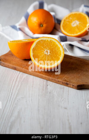 Halved and whole oranges, side view. Close-up. Space for text. Stock Photo
