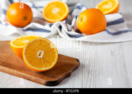 Halved and whole oranges, side view. Close-up. Copy space. Stock Photo