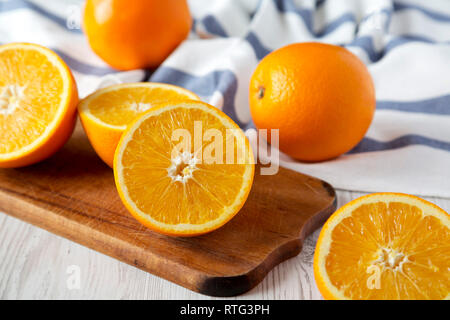 Halved and whole oranges, side view. Closeup. Selective focus. Stock Photo