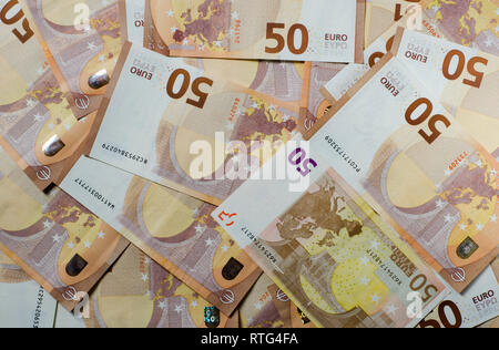 Many banknotes euro 50 lies on a white background wood with copy space top view Stock Photo